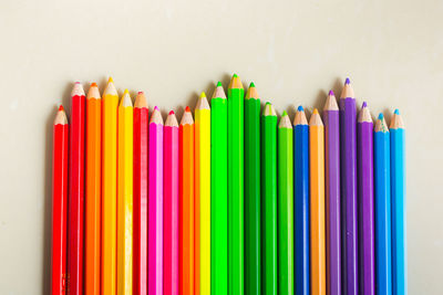 Close-up of colorful pencils against colored background