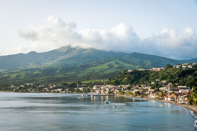 Scenic view of sea and mountains against sky