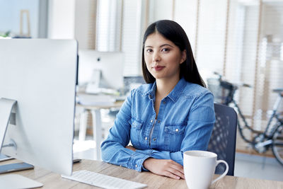 Portrait of a woman working on table