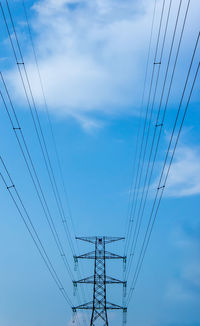 Low angle view of electricity pylon against sky