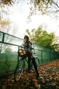 Portrait of young woman in park during autumn