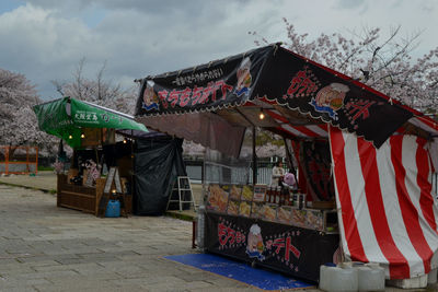 Various flags hanging at market stall