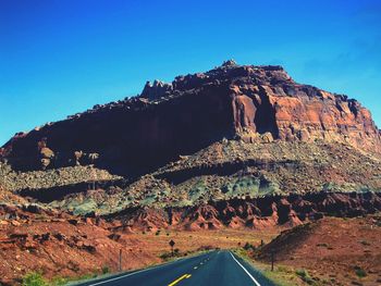 View of rock formation against clear blue sky