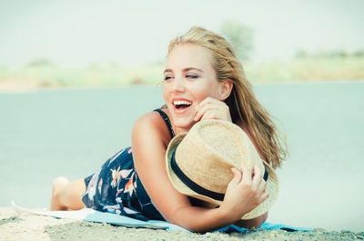 Portrait of smiling young woman at beach