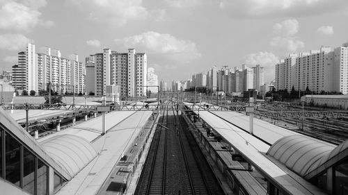 High angle view of railroad tracks amidst buildings in city