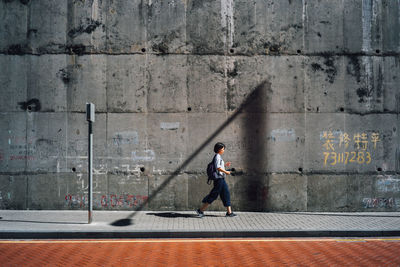 Full length of woman standing by railing