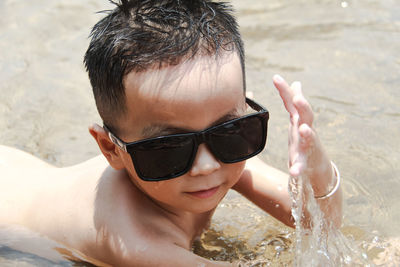 Cute boy lying on seashore