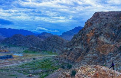 Scenic view of mountains against cloudy sky