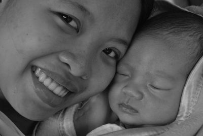 Portrait of smiling mother with baby