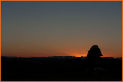 Silhouette of landscape against sky at sunset