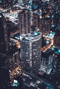 High angle view of illuminated buildings in city at night