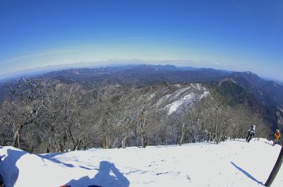 Scenic view of snow covered mountains against clear sky