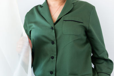 Midsection of man standing against white background