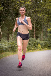 Smiling woman running on road