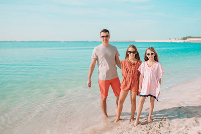 Full length of woman on beach against sky