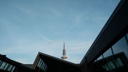 Low angle view of building against cloudy sky