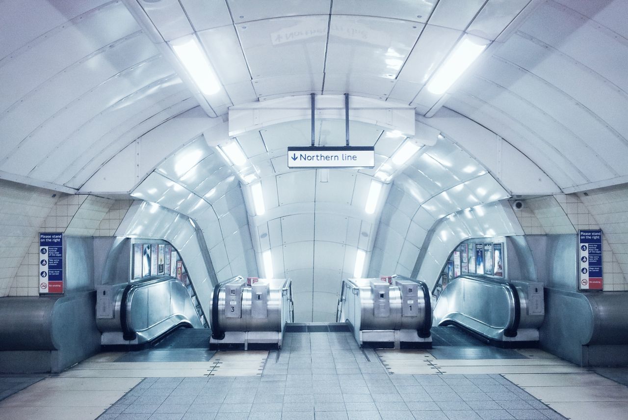 indoors, ceiling, architecture, illuminated, built structure, arch, interior, corridor, flooring, empty, tiled floor, the way forward, subway, lighting equipment, tile, subway station, railroad station, wall - building feature, absence, transportation