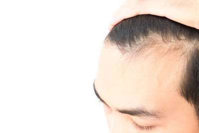 Close-up of young woman over white background