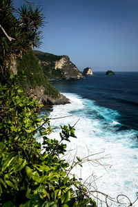 Scenic view of sea against clear blue sky