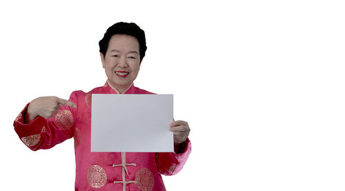 Portrait of a smiling man standing against white background