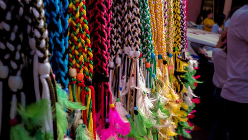 Multi colored bracelets hanging for sale at market stall