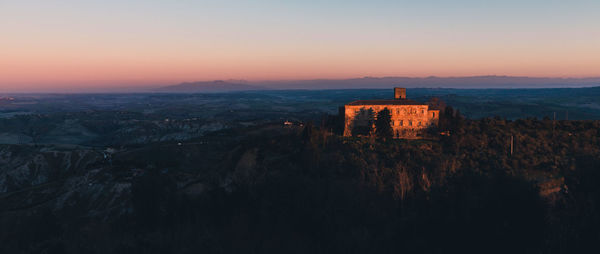 Panoramic view of old building against sky during sunset