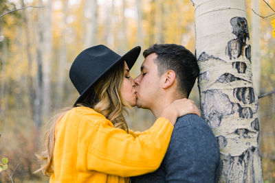 Portrait of young couple kissing outdoors