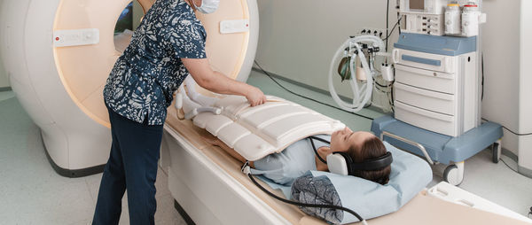 Midsection of nurse scanning patient at hospital