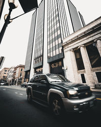 Car in city against sky