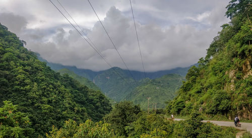Panoramic view of trees and mountains against sky