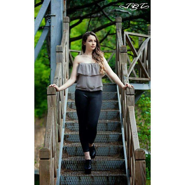 young adult, looking at camera, full length, casual clothing, person, portrait, standing, lifestyles, front view, railing, steps, young women, leisure activity, built structure, staircase, architecture, steps and staircases, smiling