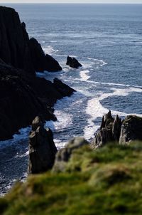 Rock formation on beach against sky