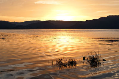 Scenic view of silhouette mountains against sky during sunset