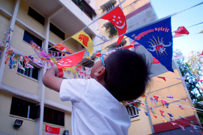 Boy on multi colored umbrella