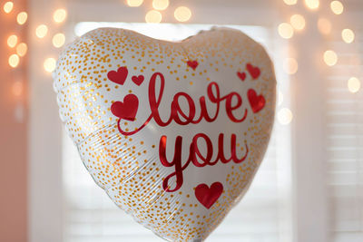 Close-up of text on heart shape balloon