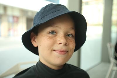 Close-up portrait of smiling boy at cafe