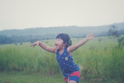 Full length of girl standing on field