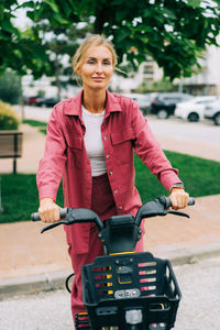 A young woman uses an urban rented electric bike. green energy.