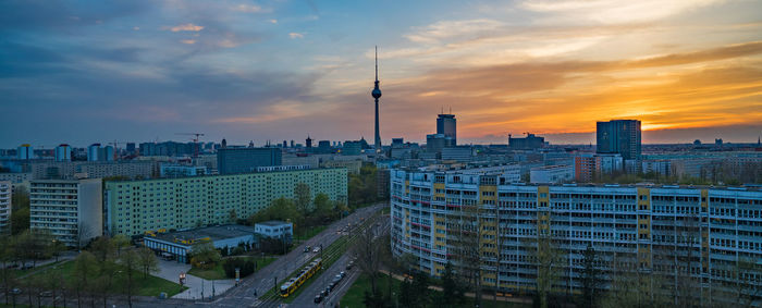 Buildings and television tower - berlin against sky during sunset