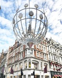 Low angle view of building against cloudy sky