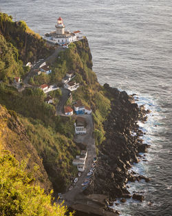 View of farol do arnel, the oldest lighthouse on sao miguel island, azores