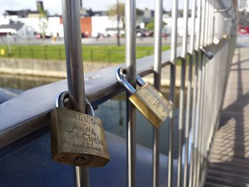 Close-up of padlocks on railing