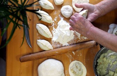 Cropped hands of person preparing food