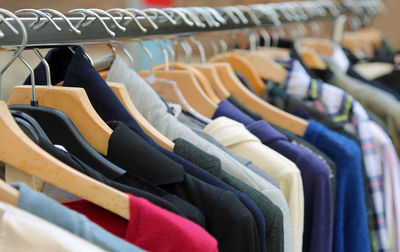 Row of clothes hanging on rack in store