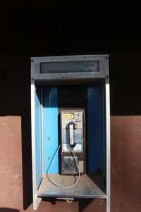 Telephone booth against wall