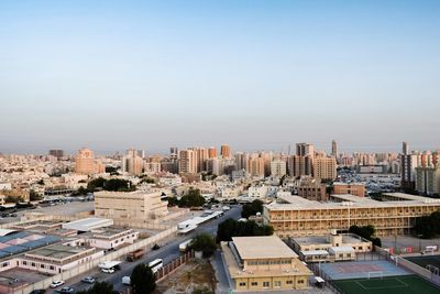 High angle view of buildings in city against clear sky