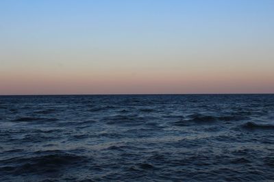 Scenic view of sea against clear sky during sunset