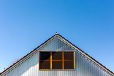 Low angle view of building against clear blue sky