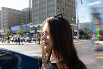 Woman standing on road during sunny day