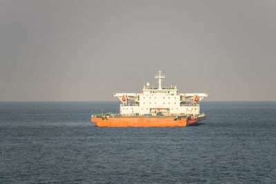 View of ship in sea against clear sky